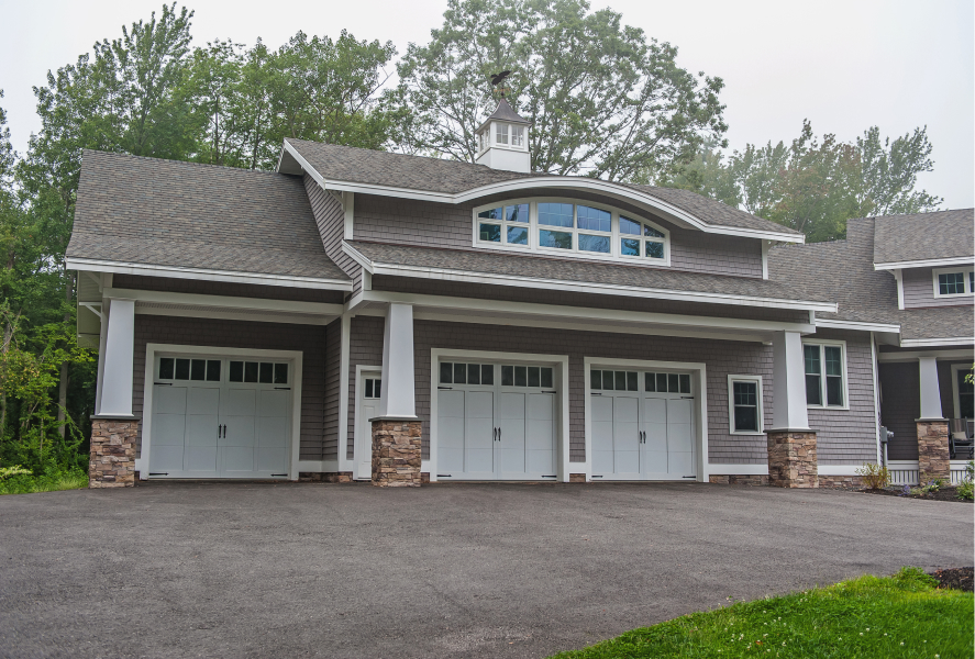 Stamped carriage house garage doors in white