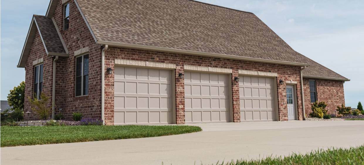 Recessed panel ranch-style garage doors in sandstone