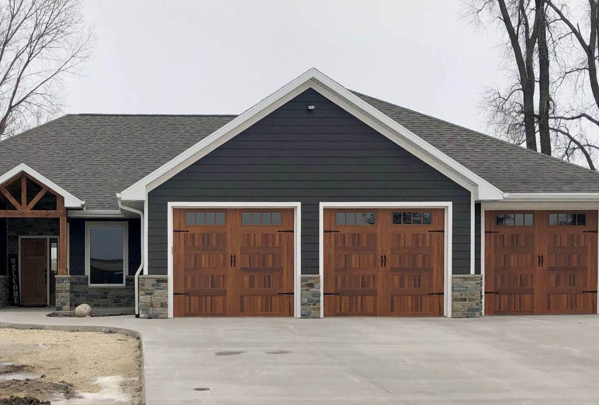 Stamped carriage house ranch-style garage doors in woodtone