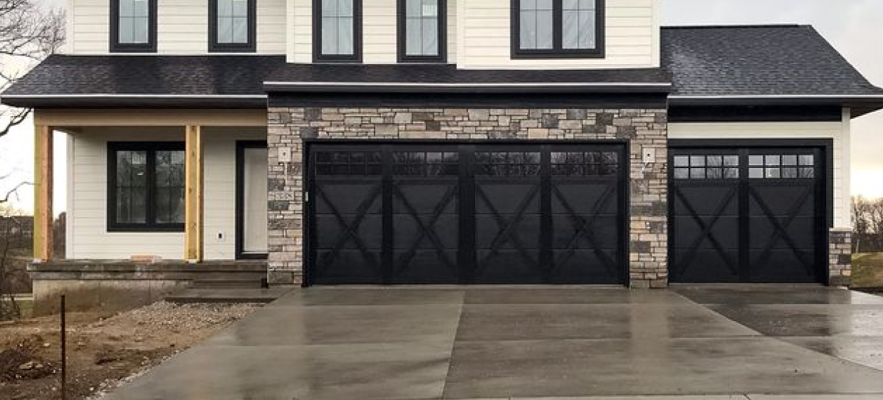 Steel overlay carriage house ranch-style garage doors in black