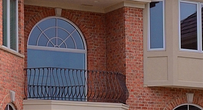 Close up of rounded window with balcony