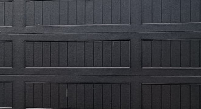 Stamped carriage house black garage door texture