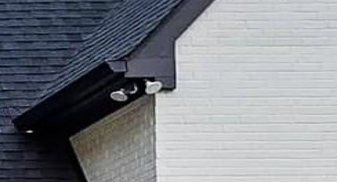 close up of white brick and black roof